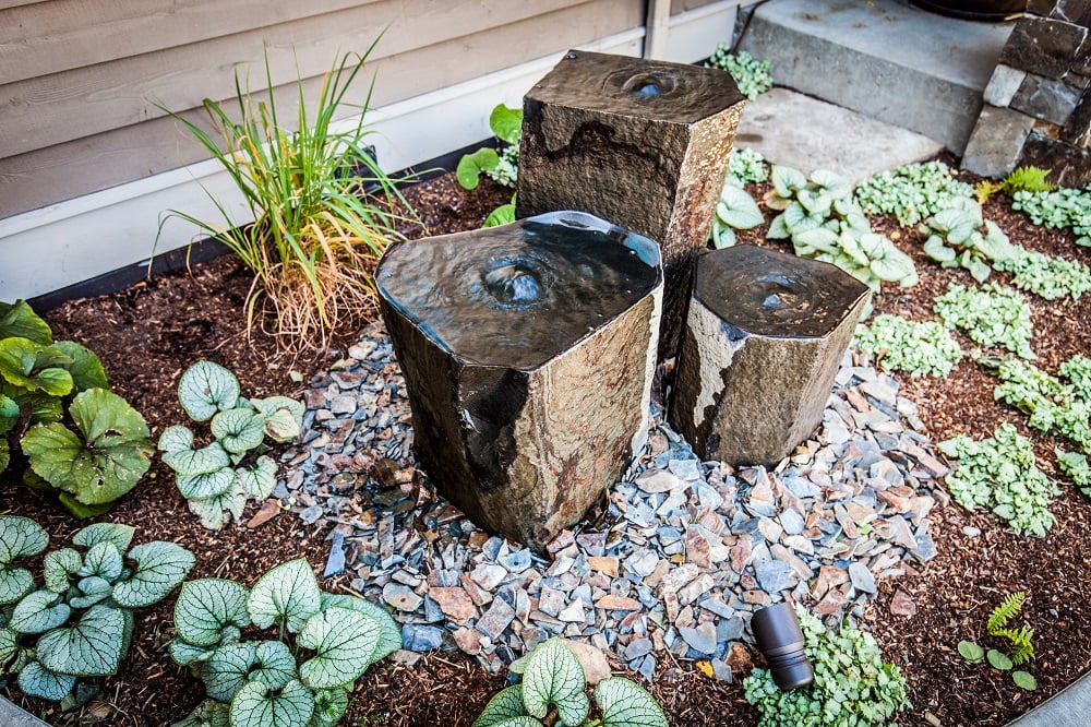 Landscape water feature at entrance to home