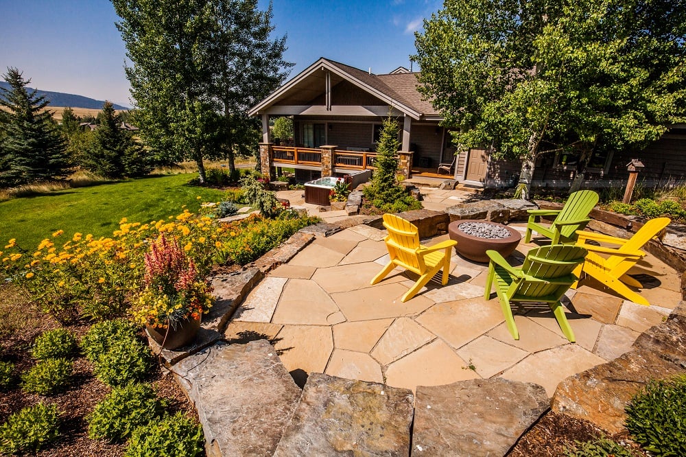 patio with firepit and gardens matching color of home