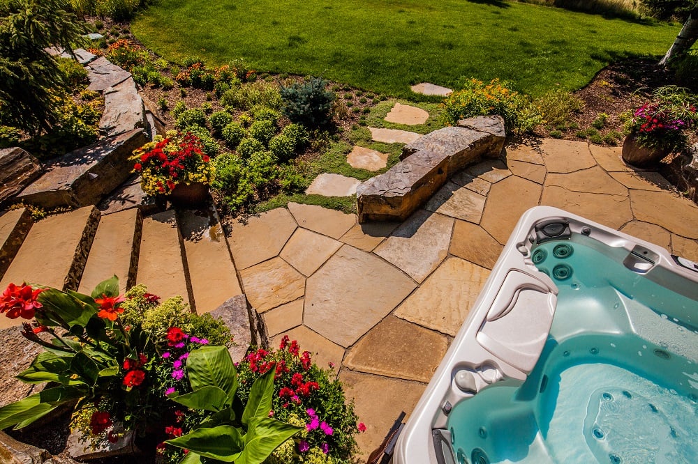 sloped landscape with stairs, plants, and walkway