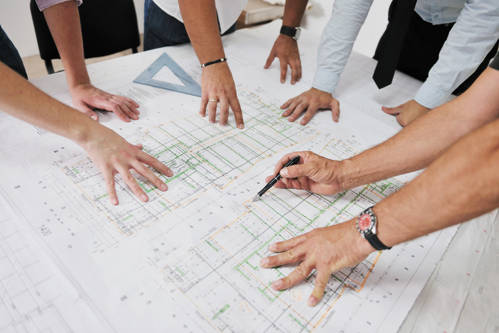 team looks at site plans