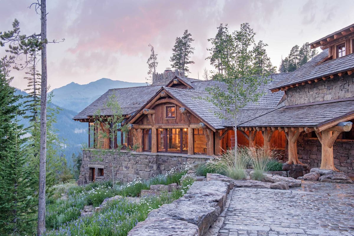 log cabin with stone driveway