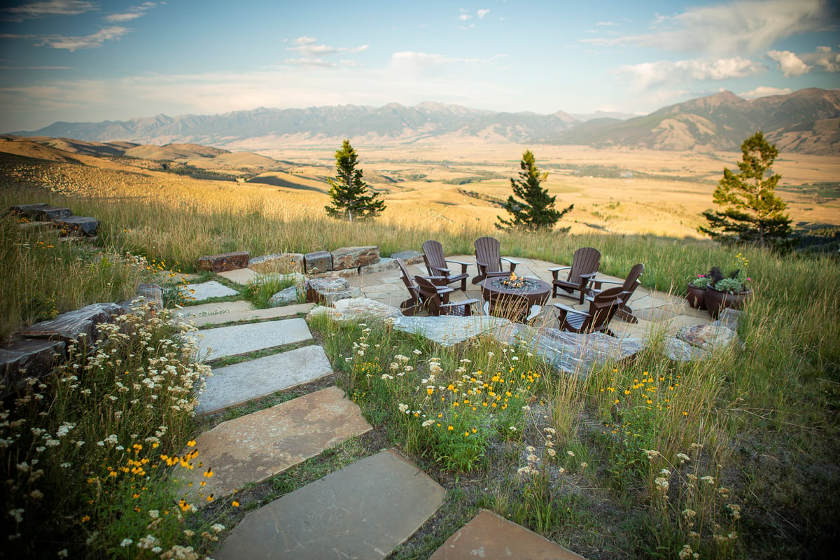 firepit and patio surrounded by native plantings and mountain view