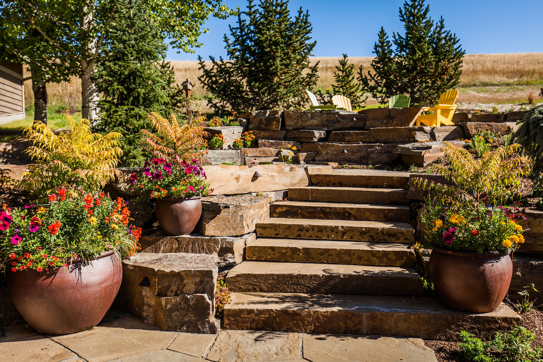 Stone patio and steps enhanced with container gardens