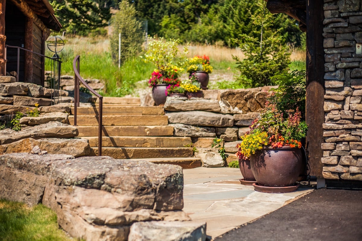 sloped landscape with steps and container plants