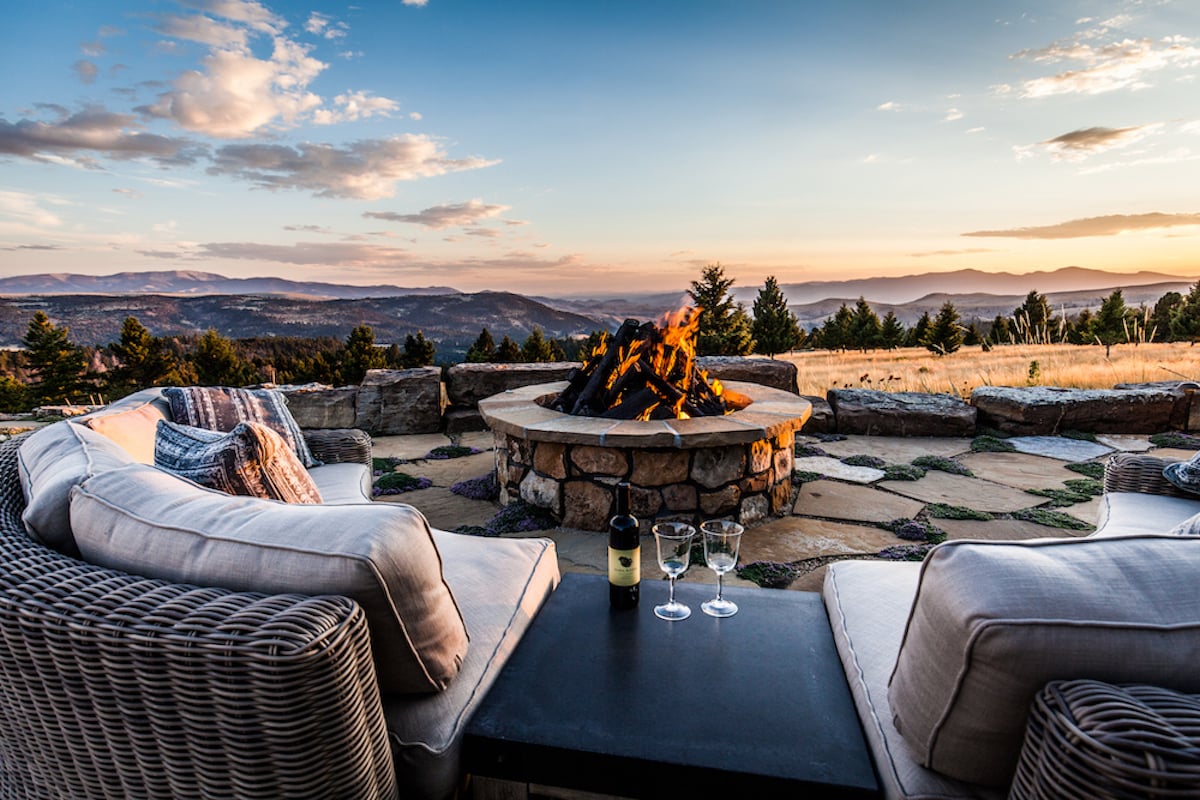 fire pit with patio and sitting area with view of mountains in Montana