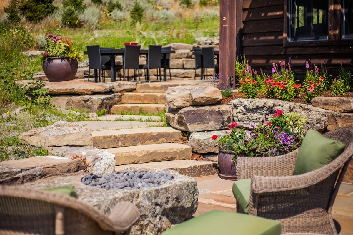 patio design with steps, fire bowl, flowers and chairs