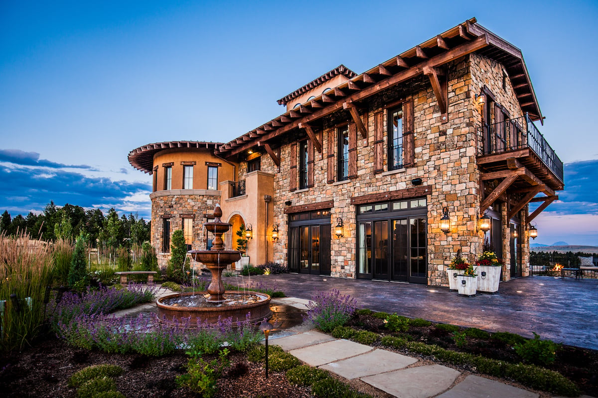 tuscan home with plantings and water feature