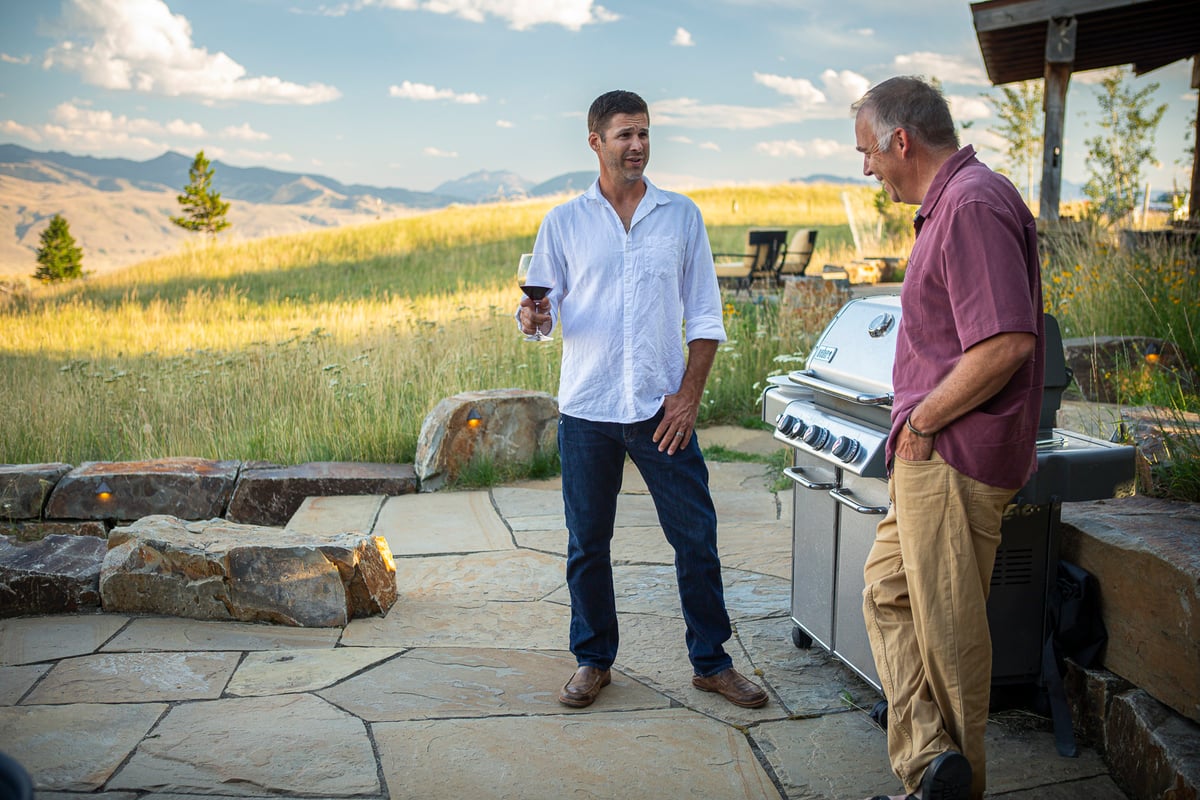 homeowners talk near grill