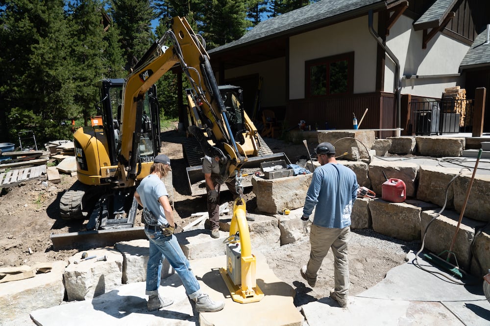 landscaping team install large stone pavers