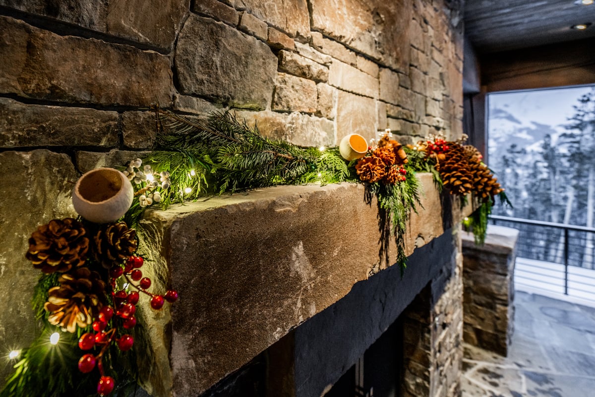 evergreen with lights and decorations on mantel 