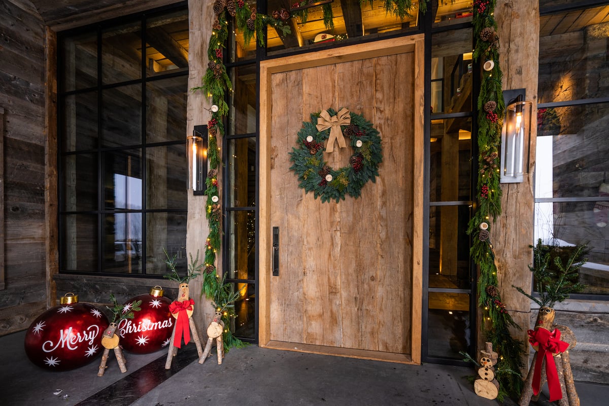 live garland and holiday decorations near front door