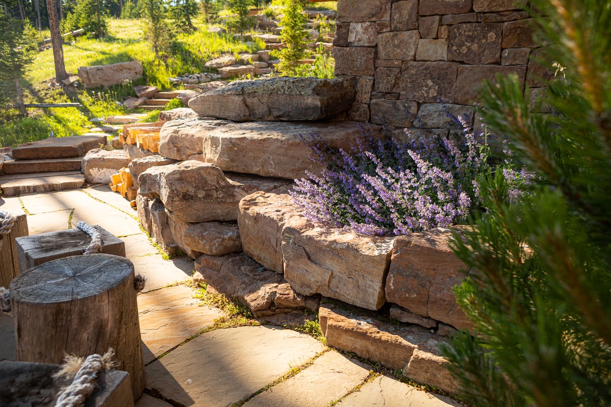 boulder wall with plantings to match architecture of home