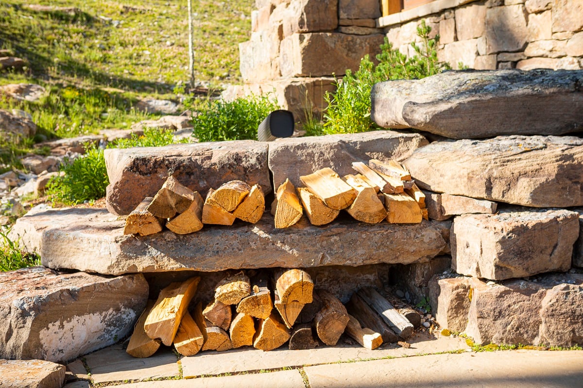 large boulders hold firewood