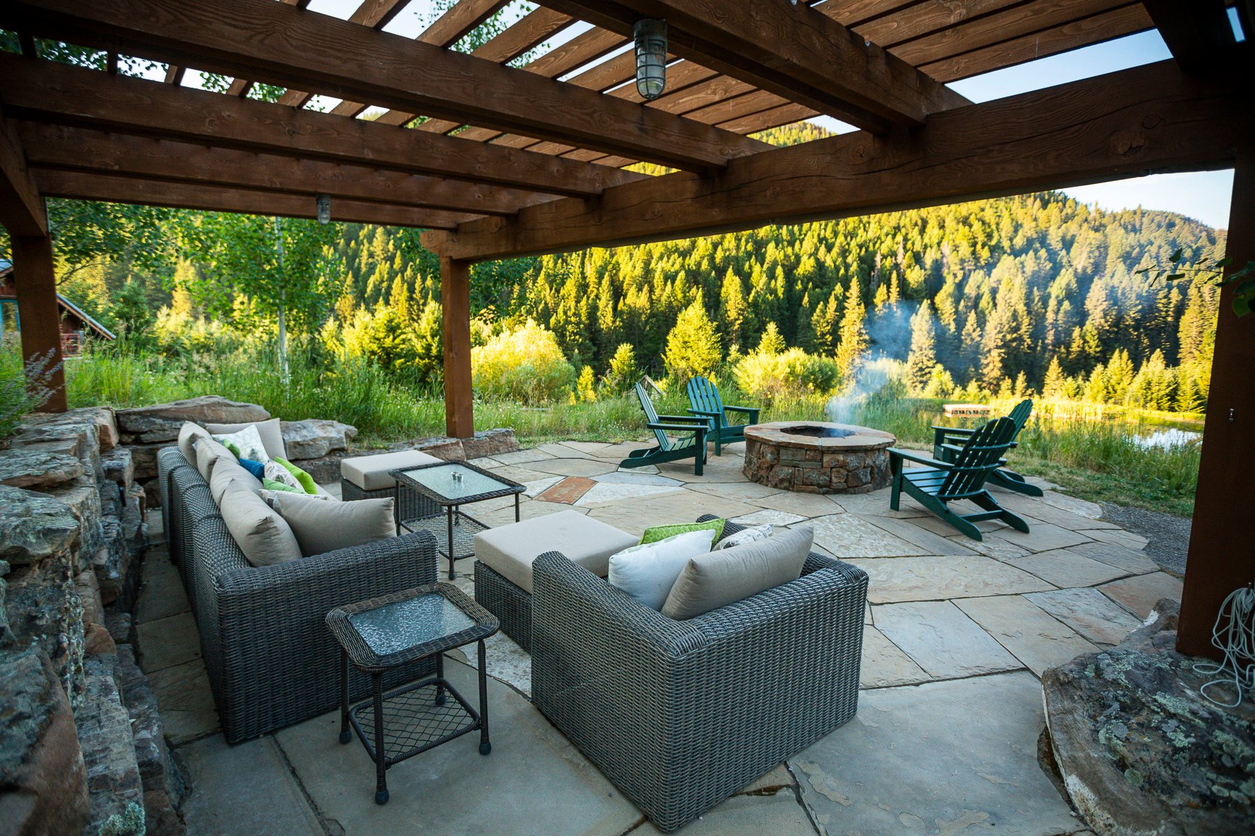 Natural stone patio with fire pit and pergola