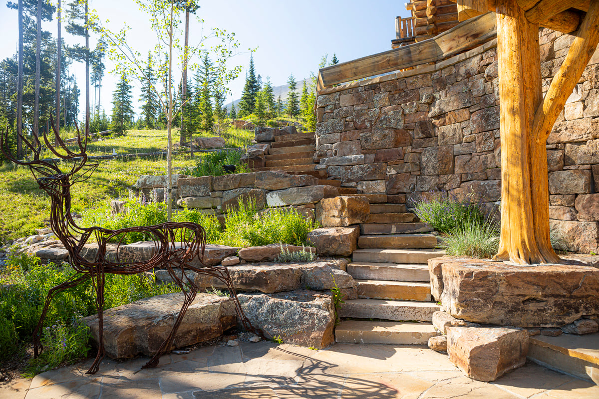 retaining wall with plantings and steps and statue