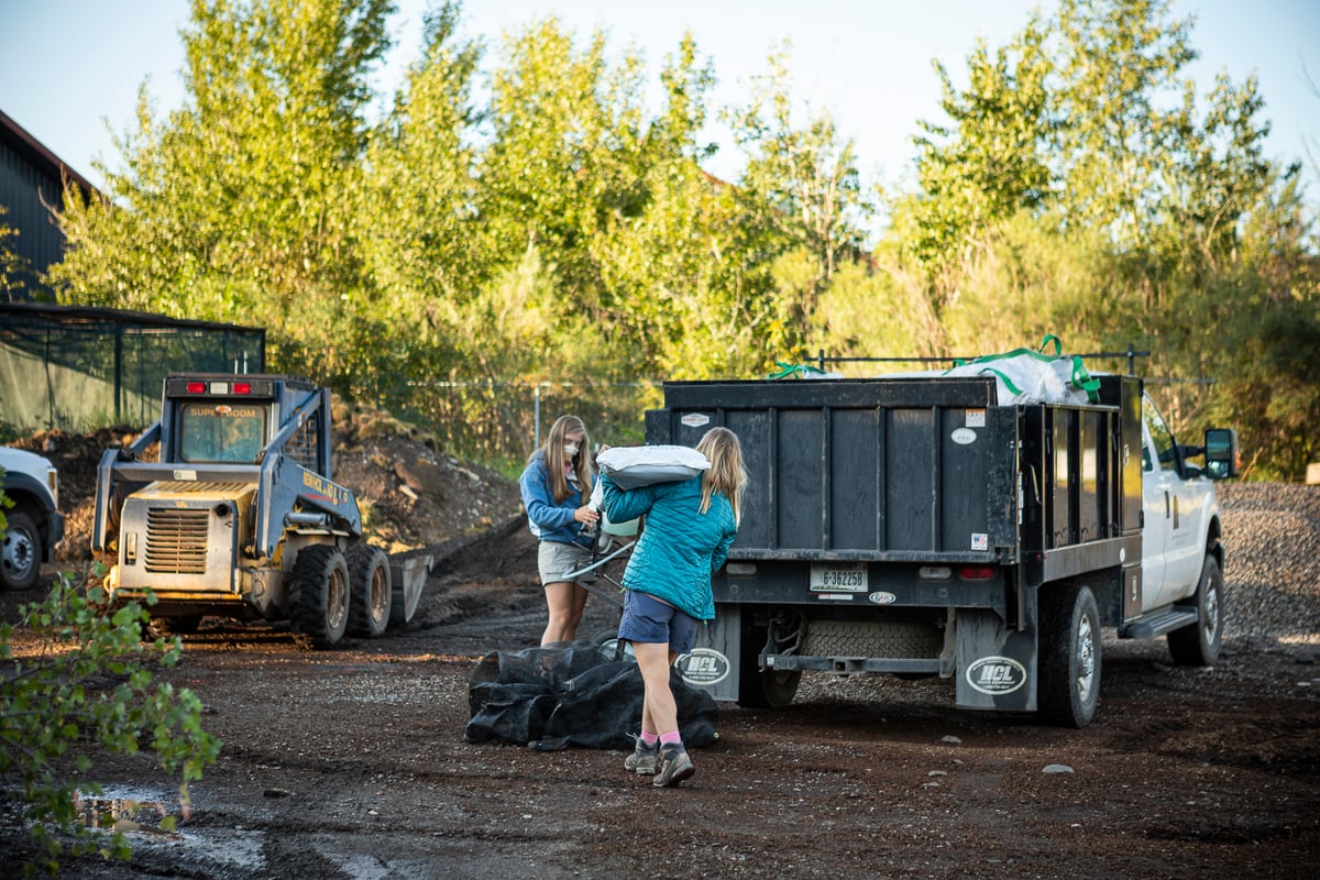 landscape team loads mulch into truck