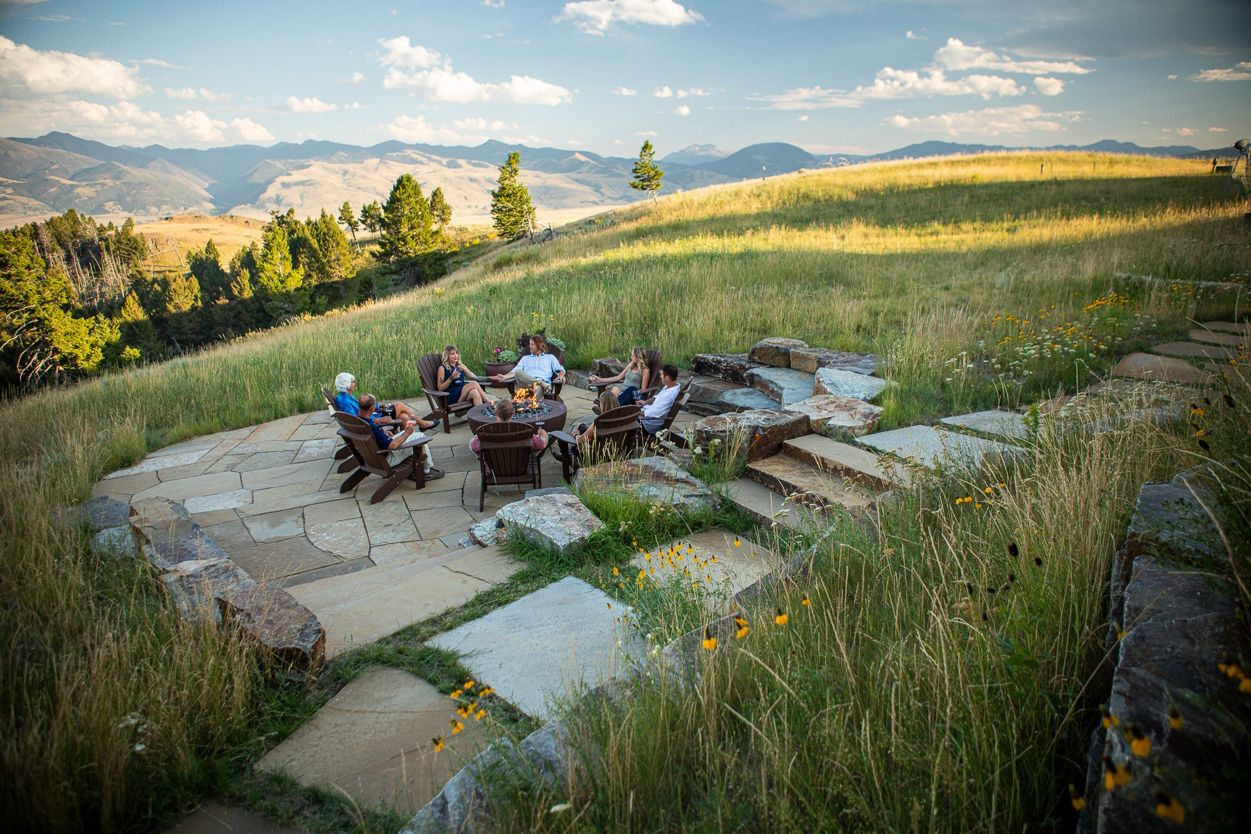 Customers enjoying fire pit and patio entertainment area