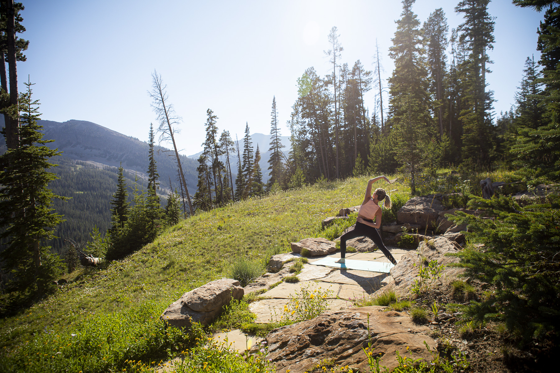 doing yoga outside with view of mountains